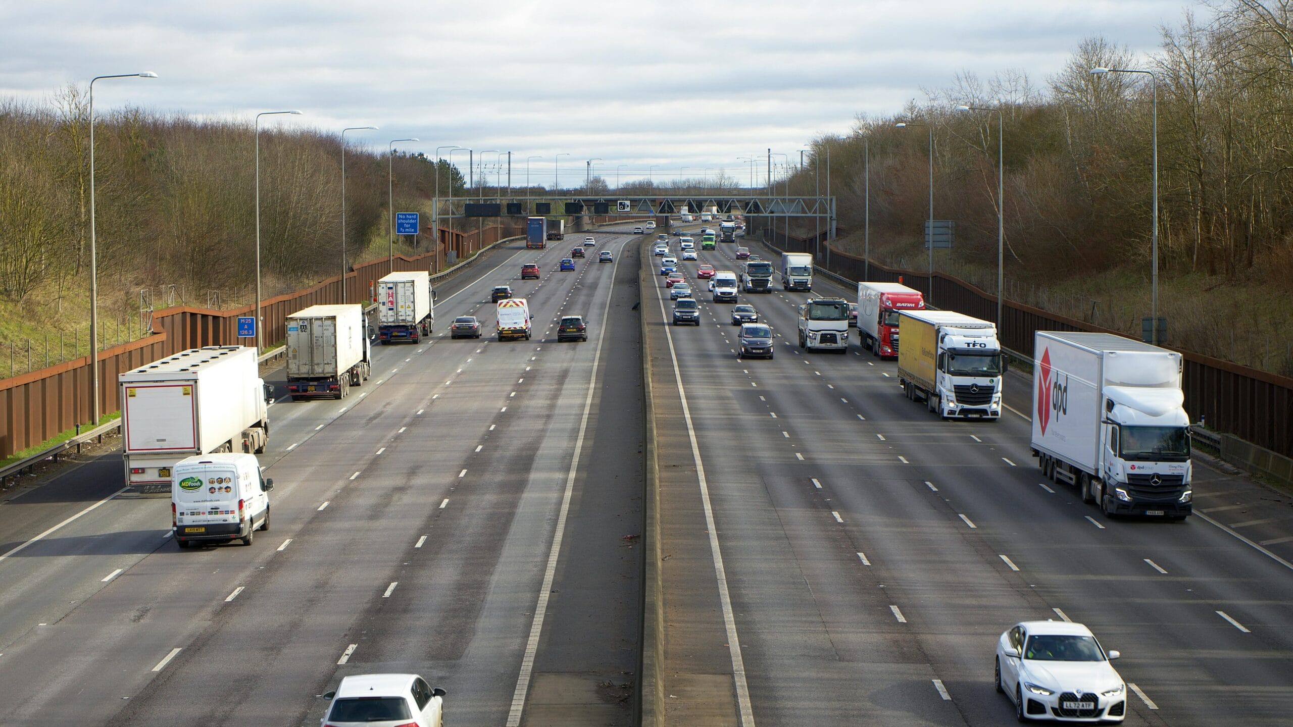 Aerial view of vehicles on a busy motorway in St Albans, UK during daylight.